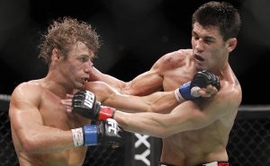 Urijah Faber, left, trades punches with Dominick Cruz during the first round of their UFC bantamweight mixed martial arts title match, Saturday, July 2, 2011 at The MGM Grand Garden Arena in Las Vegas. Cruz won by unanimous decision. (AP Photo/Eric Jamison)